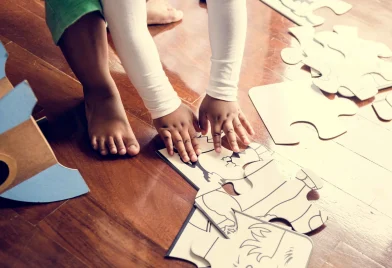 african-descent-kid-enjoying-puzzles-on-wooden-flo-2023-11-27-05-10-47-utc_11zon