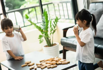 cute-sisters-playing-with-tin-can-phone-home (1)_11zon