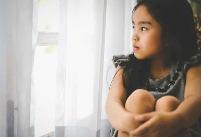 depressed-little-girl-near-window-home-closeup_11zon