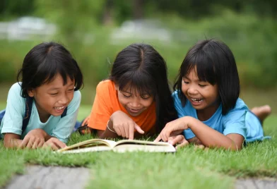 group-children-lying-reading-grass-field_11zon