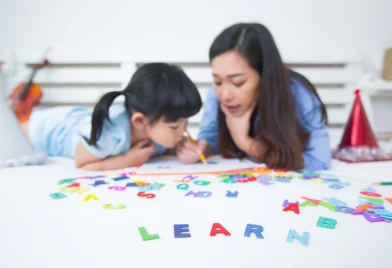 mother-daughter-studying-alphabet