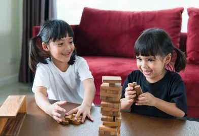 two-asian-girl-playing-wooden-stacks-at-home-2023-11-27-04-49-04-utc_11zon