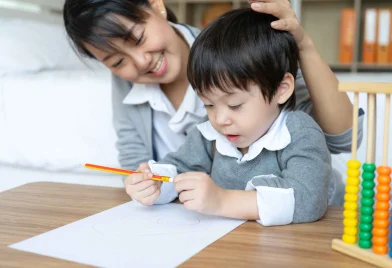 young-mother-teaching-her-son-write-paper-with-love_11zon